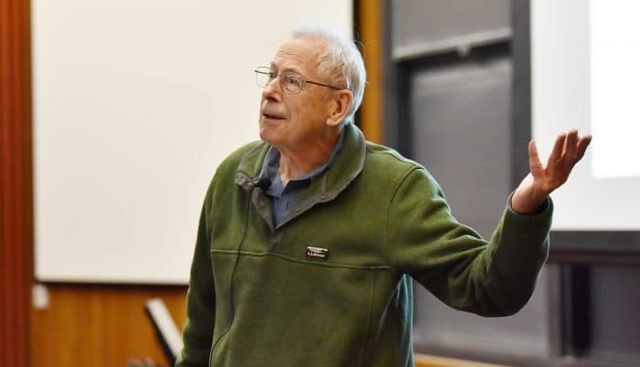 Dr. James Peebles WF ’58 speaking to an off-camera audience in a classroom