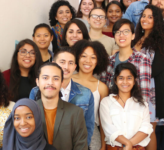 a group of graduate students standing on stairs at a seminar